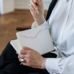 Person in White Dress Shirt Holding White Paper